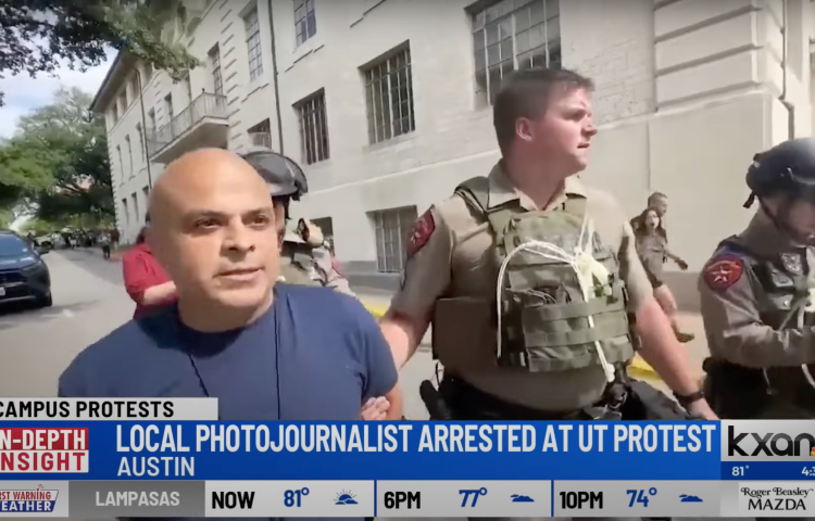 FOX 7 Austin photojournalist Carlos Sanchez arrested and being led away by authorities on April 24. (Photo: KXAN/YouTube)